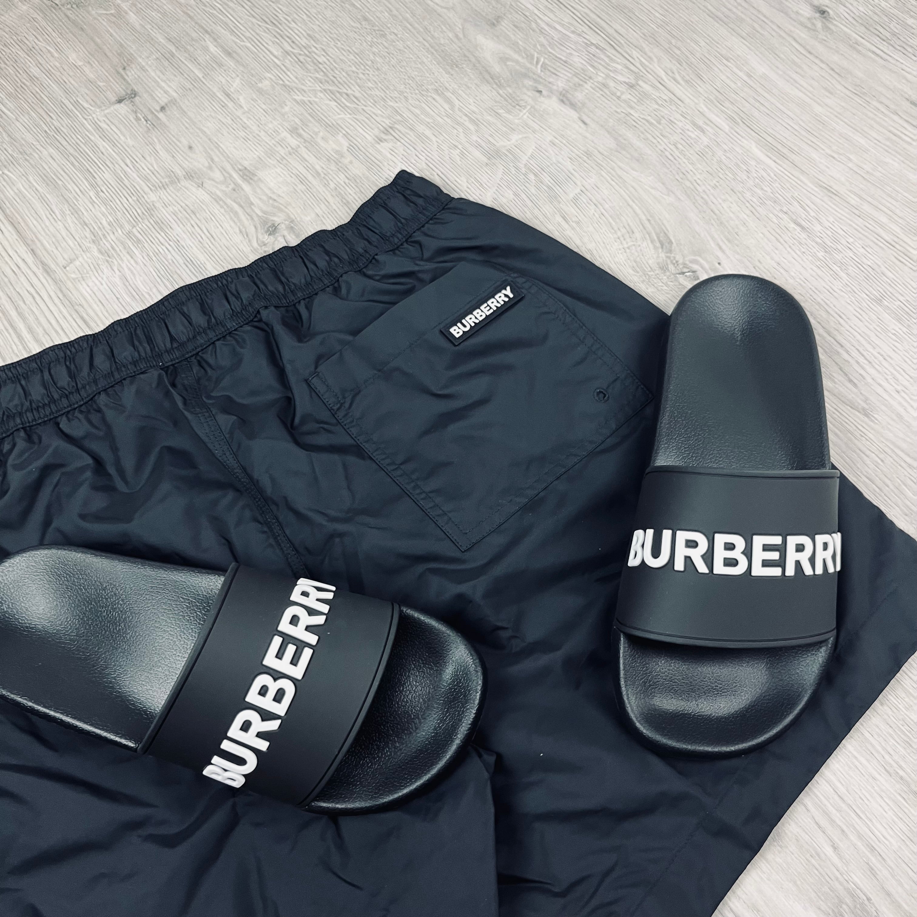 Burberry Holiday Set consisting of slides and swim shorts in Black. On sale at Open Attire.