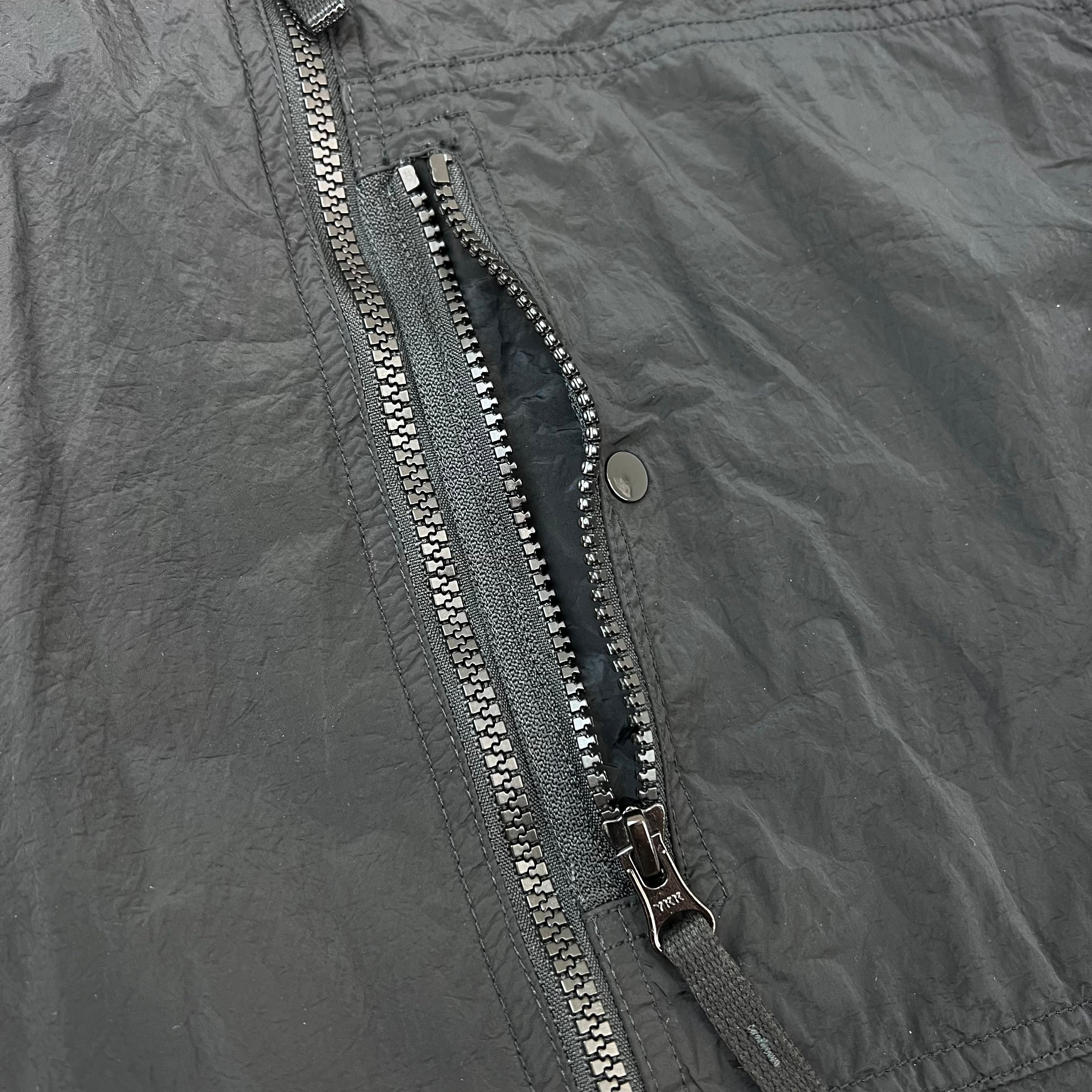 A close view of the zip chest pocket on a Stone Island Nylon Metal Overshirt in Black.