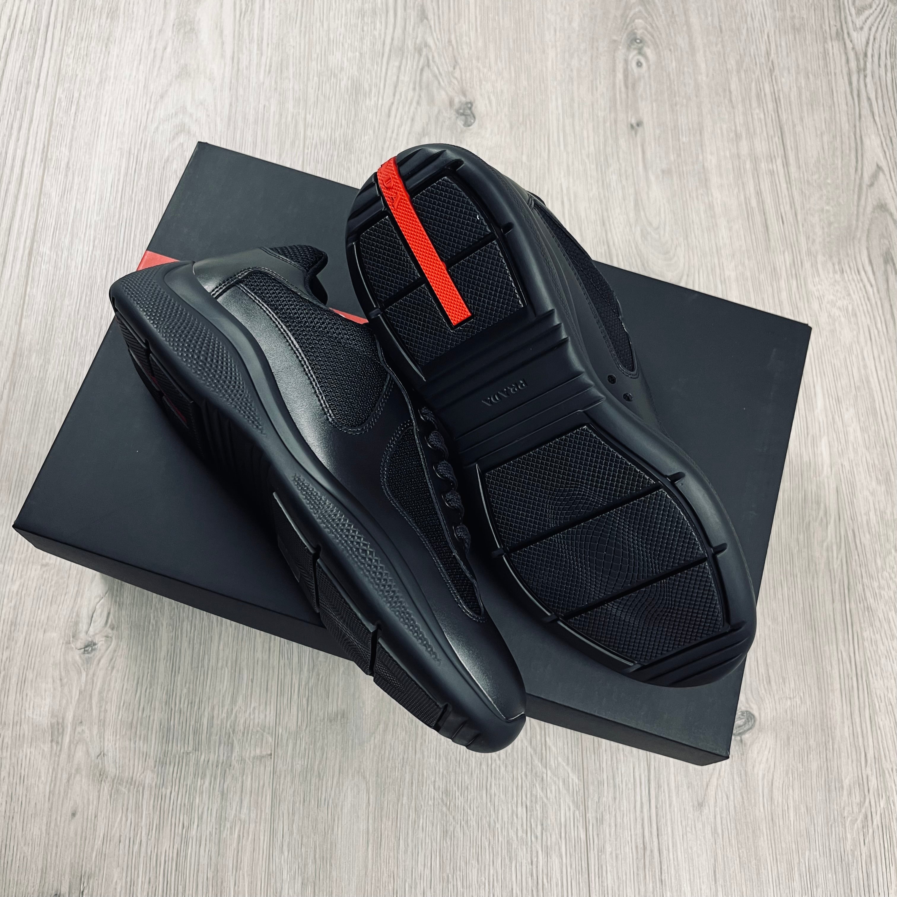 Prada Americas Cup Sneakers in Black. On sale at Open Attire