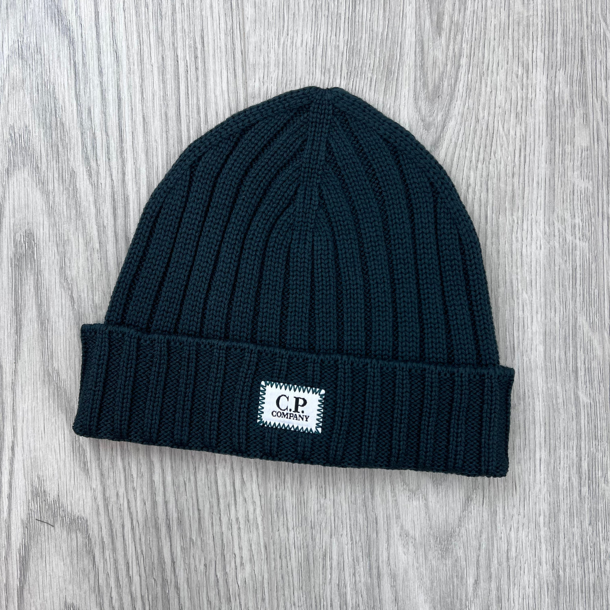 Front view of the CP Company Merino Wool Patch Beanie in Ponderosa Pine .