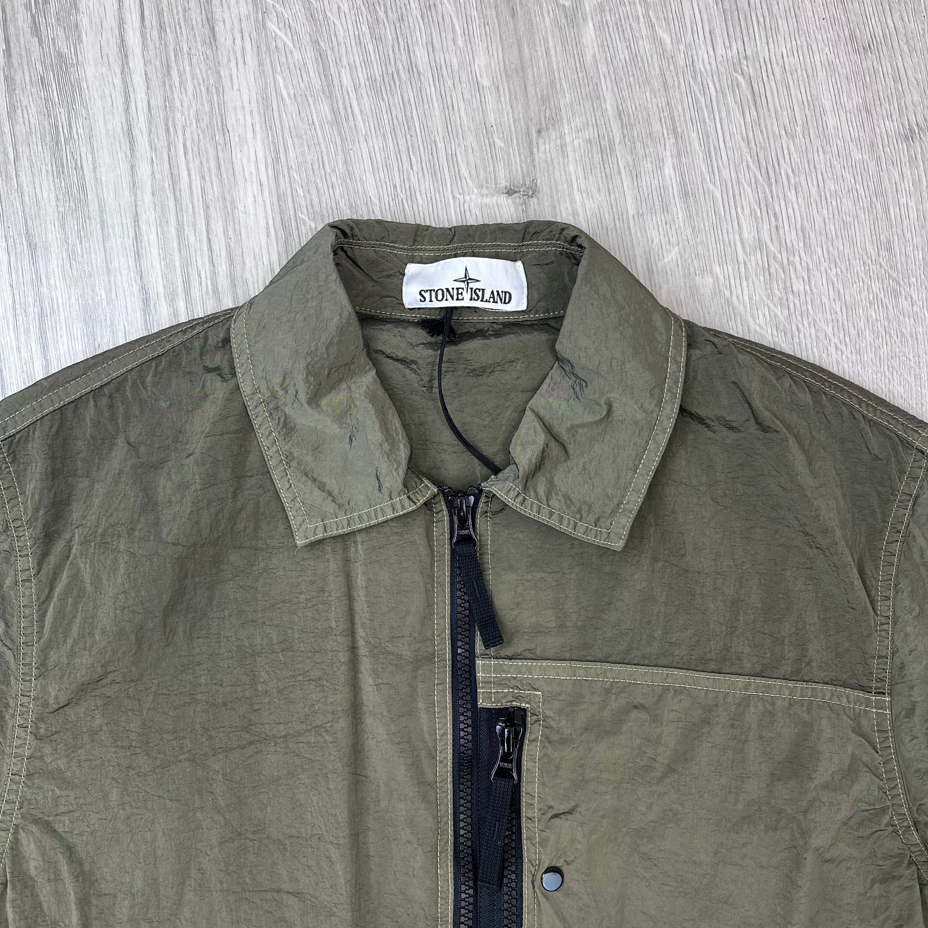 A close up view of the classic collar and neck label on a Stone Island Nylon Metal Overshirt in Military Green.