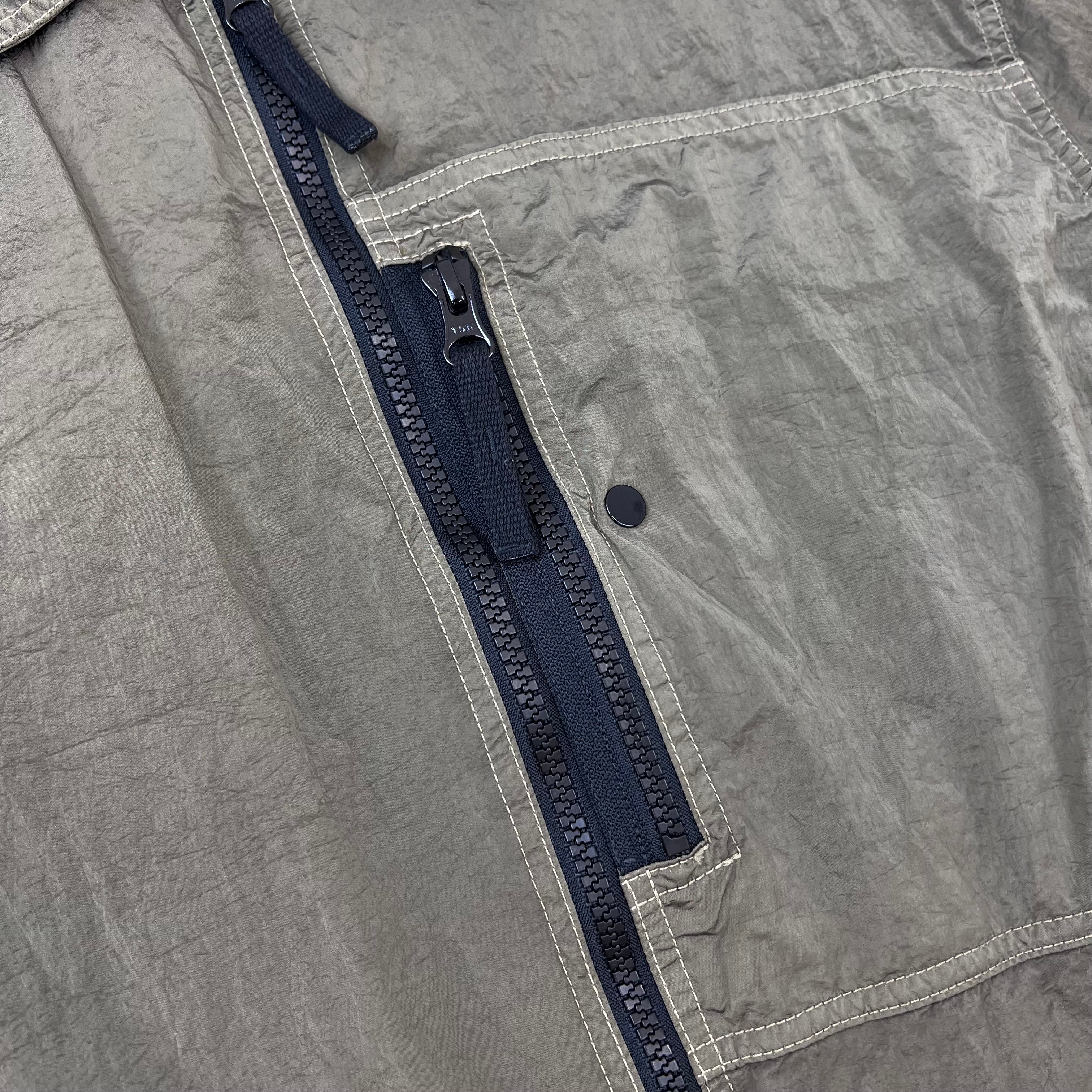 A close view of the zip chest pocket on a Stone Island Nylon Metal Overshirt in Military Green.