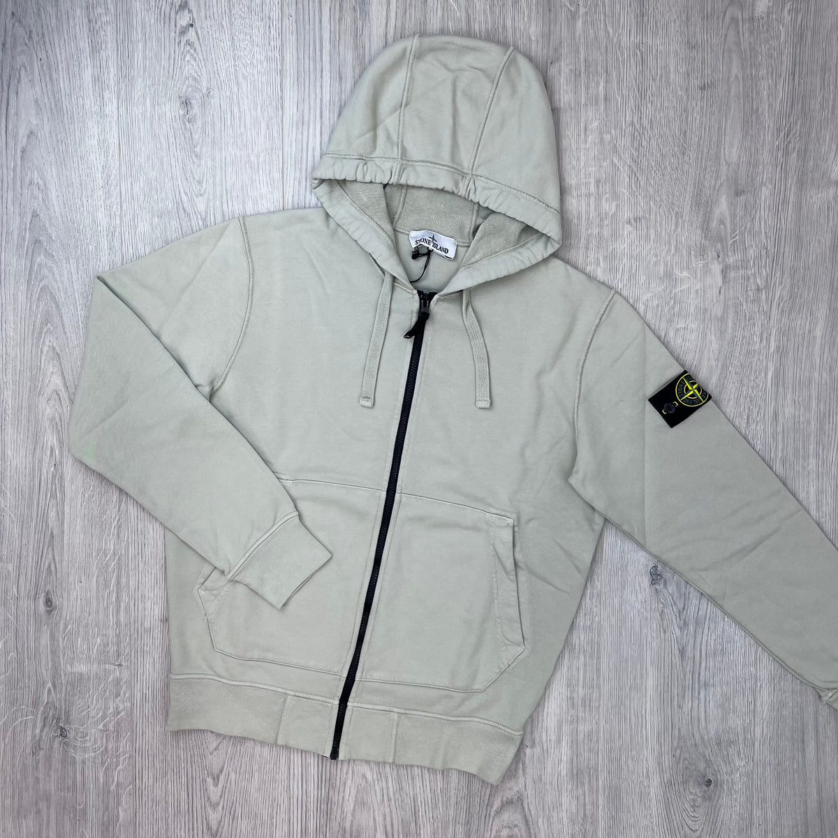 Front view of the Stone Island Zip Hoodie in Sand. 